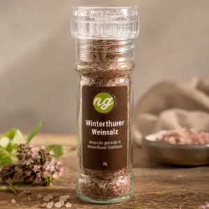 Glass spice bottle filled with pink salt crystals, labeled 'Winterthurer Weinsalz' (80 g), brand 'ng' visible on the dark label.