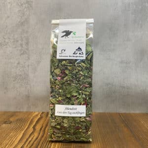 Tall bag of loose herbal tea with green leaves and pink petals, labeled Abendrot 'Lass den Tag ausklingen'.